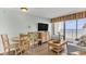 Living room area with ocean view, a TV, a couch, a table, and chairs at 6804 N Ocean Blvd. # 533, Myrtle Beach, SC 29572