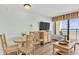 Cozy living room area with a table, tv and a walk out patio at 6804 N Ocean Blvd. # 533, Myrtle Beach, SC 29572