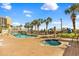 A pool area features a jacuzzi, a bridge, and palm trees. A perfect spot to relax and unwind at 6804 N Ocean Blvd. # 533, Myrtle Beach, SC 29572