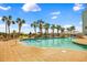 Outdoor swimming pool surrounded by palm trees, lounge chairs, and a bridge to a center island at 6804 N Ocean Blvd. # 533, Myrtle Beach, SC 29572