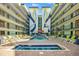 Resort-style outdoor pool and hot tub area surrounded by colorful buildings and lounging chairs at 6804 N Ocean Blvd. # 533, Myrtle Beach, SC 29572