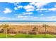 Scenic beach view from a well-maintained lawn, complete with hammocks and tropical palm trees at 6900 N Ocean Blvd. # 837, Myrtle Beach, SC 29572