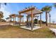 Inviting picnic area featuring wooden pergolas, picnic tables, and scenic beach views surrounded by palm trees at 6900 N Ocean Blvd. # 837, Myrtle Beach, SC 29572