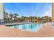 Outdoor pool area with lounge chairs, play area, and beautiful palm tree landscaping at 6900 N Ocean Blvd. # 837, Myrtle Beach, SC 29572