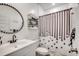 Stylish bathroom featuring a round mirror and a shower with a decorative curtain at 694 Harrison Mill St., Myrtle Beach, SC 29579