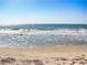 Picturesque beach with ocean waves gently rolling onto the sandy shore under a clear sky at 694 Harrison Mill St., Myrtle Beach, SC 29579