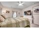 Bright bedroom featuring a large screen television and a bed with decorative pillows at 694 Harrison Mill St., Myrtle Beach, SC 29579