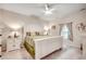 Bright bedroom featuring a ceiling fan and a bed with white frame and decorative pillows at 694 Harrison Mill St., Myrtle Beach, SC 29579