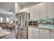 Modern kitchen with stainless steel refrigerator and white cabinets, adjacent to the inviting living area at 694 Harrison Mill St., Myrtle Beach, SC 29579