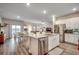 Open-concept kitchen with a granite island and stainless steel appliances adjacent to a cozy dining and living area at 694 Harrison Mill St., Myrtle Beach, SC 29579