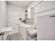 Well-lit laundry room with washer, dryer, shelving, and a folding table at 694 Harrison Mill St., Myrtle Beach, SC 29579