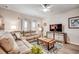 Cozy living room with a comfortable sectional sofa, ceiling fan, and view to the backyard at 694 Harrison Mill St., Myrtle Beach, SC 29579