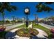 Decorative clock set on a landscaped island, surrounded by palm trees and scenic buildings at 694 Harrison Mill St., Myrtle Beach, SC 29579