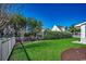 Backyard view showcasing the lawn, fence, and landscaping with mature trees at 726 Carolina Farms Blvd., Myrtle Beach, SC 29579