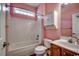 Cozy bathroom featuring a tub, shower combo, wooden vanity and a white storage cabinet at 726 Carolina Farms Blvd., Myrtle Beach, SC 29579