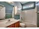 Bathroom featuring tub and shower combo, wooden vanity, and white storage cabinet with neutral colors at 726 Carolina Farms Blvd., Myrtle Beach, SC 29579