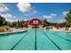 Stunning community pool with lounge chairs and a charming red barn-style building in the background at 726 Carolina Farms Blvd., Myrtle Beach, SC 29579