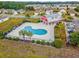 Aerial view of a community pool with an adjacent barn style community center and parking at 726 Carolina Farms Blvd., Myrtle Beach, SC 29579