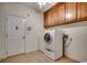 Functional laundry room with cabinets, tile floors, and modern washer and dryer units at 726 Carolina Farms Blvd., Myrtle Beach, SC 29579