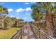 Beautiful beach access path with a gazebo, framed by lush greenery and palm trees at 7609 Brentwood Dr., Myrtle Beach, SC 29572