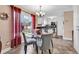 Dining room with a glass table and chairs next to the kitchen area and a large window at 7609 Brentwood Dr., Myrtle Beach, SC 29572