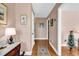 Hallway entrance features beautiful hardwood floors, soft neutral walls, and a decorative table at 7609 Brentwood Dr., Myrtle Beach, SC 29572