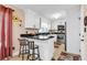 Cozy kitchen area featuring granite countertops, white cabinets, stainless steel appliances, and barstool seating at 7609 Brentwood Dr., Myrtle Beach, SC 29572