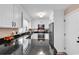 Bright kitchen featuring white cabinets, stainless steel appliances, and sleek black countertops at 7609 Brentwood Dr., Myrtle Beach, SC 29572