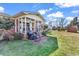 A brick home's rear exterior boasts a screened porch and well-maintained lawn at 7609 Brentwood Dr., Myrtle Beach, SC 29572