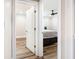 View through doorway of bedroom with bed and storage, ceiling fan and wood flooring at 8533 Cedar Trace Dr., Myrtle Beach, SC 29588