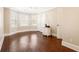 Bright bedroom with wood floors, neutral walls, and natural light from multiple windows at 8533 Cedar Trace Dr., Myrtle Beach, SC 29588