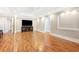 Open-concept living room with hardwood floors, a tray ceiling, recessed lighting, and an entertainment center at 8533 Cedar Trace Dr., Myrtle Beach, SC 29588