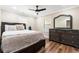 Cozy main bedroom with wood floors, ceiling fan, large window, and furniture at 8533 Cedar Trace Dr., Myrtle Beach, SC 29588