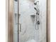 Glass shower boasts rainfall shower head and marble tile at 8533 Cedar Trace Dr., Myrtle Beach, SC 29588