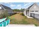 A backyard with lush green grass and landscaping, enclosed by a black wrought iron fence at 9000 Mabel Ct., Longs, SC 29568