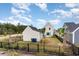 View of the back of a home with a fenced yard, landscaping, and a patio dining set at 9000 Mabel Ct., Longs, SC 29568