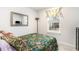 Bedroom with floral quilt, neutral walls and a window overlooking the yard at 9000 Mabel Ct., Longs, SC 29568