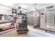 View of a finished garage space with shelving, seating, and a roll-up garage door at 9000 Mabel Ct., Longs, SC 29568