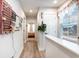 Light-filled hallway with hardwood floors leads to a cozy bedroom in this beautiful home at 9000 Mabel Ct., Longs, SC 29568