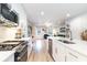 Modern kitchen featuring stainless steel appliances, white cabinetry, an island, and wood flooring at 9000 Mabel Ct., Longs, SC 29568