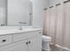 Well-lit bathroom with a white vanity, framed mirror, toilet, and shower curtain at 100 Cypress Point Ct. # 105, Myrtle Beach, SC 29579