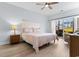 Relaxing bedroom with comfy quilt and sliding glass doors to a garden view at 100 Cypress Point Ct. # 105, Myrtle Beach, SC 29579