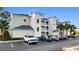 Exterior view of the building featuring well-maintained landscaping and ample parking space at 100 Cypress Point Ct. # 105, Myrtle Beach, SC 29579