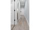 Hallway with wood-style floors and white trim leads to a bright room at 100 Cypress Point Ct. # 105, Myrtle Beach, SC 29579