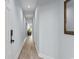 Well-lit hallway featuring wood-style floors leading to a living room at 100 Cypress Point Ct. # 105, Myrtle Beach, SC 29579