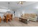 Open-concept living room with modern decor, light floors and sliding barn door for laundry at 100 Cypress Point Ct. # 105, Myrtle Beach, SC 29579