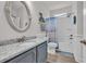 Bright bathroom featuring a granite vanity, rope-trimmed mirror, and a tub with a shower at 1016 Longwood Bluffs Circle, Murrells Inlet, SC 29576