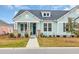 Charming cottage-style home with light blue shake siding and inviting front porch at 1016 Longwood Bluffs Circle, Murrells Inlet, SC 29576