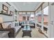 Cozy sunroom with wicker furniture, plush cushions, and ample natural light from large windows at 1016 Longwood Bluffs Circle, Murrells Inlet, SC 29576