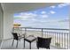 Breathtaking ocean view from the balcony seating area with chairs and end table overlooking the beach at 107 S Ocean Blvd. # 602, Myrtle Beach, SC 29577